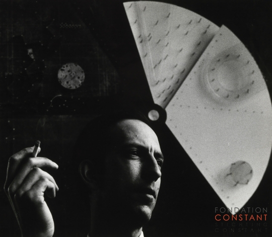 Constant Nieuwenhuys-Constant in front of Ambiance de départ, circa 1959