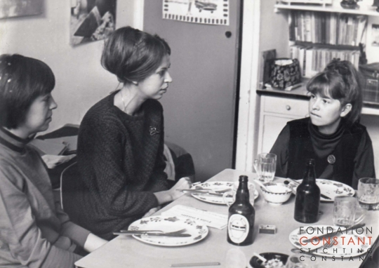 Olga, Martha And Eva Nieuwenhuys sitting around the table.