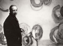 Constant in front of a mural Painting