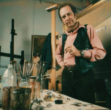 Constant standing behind a table with paint